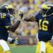 Michigan wide receiver Devin Gardner high fives senior quarterback Denard Robinson after a play during the second half at Michigan Stadium on Saturday. Melanie Maxwell I AnnArbor.com